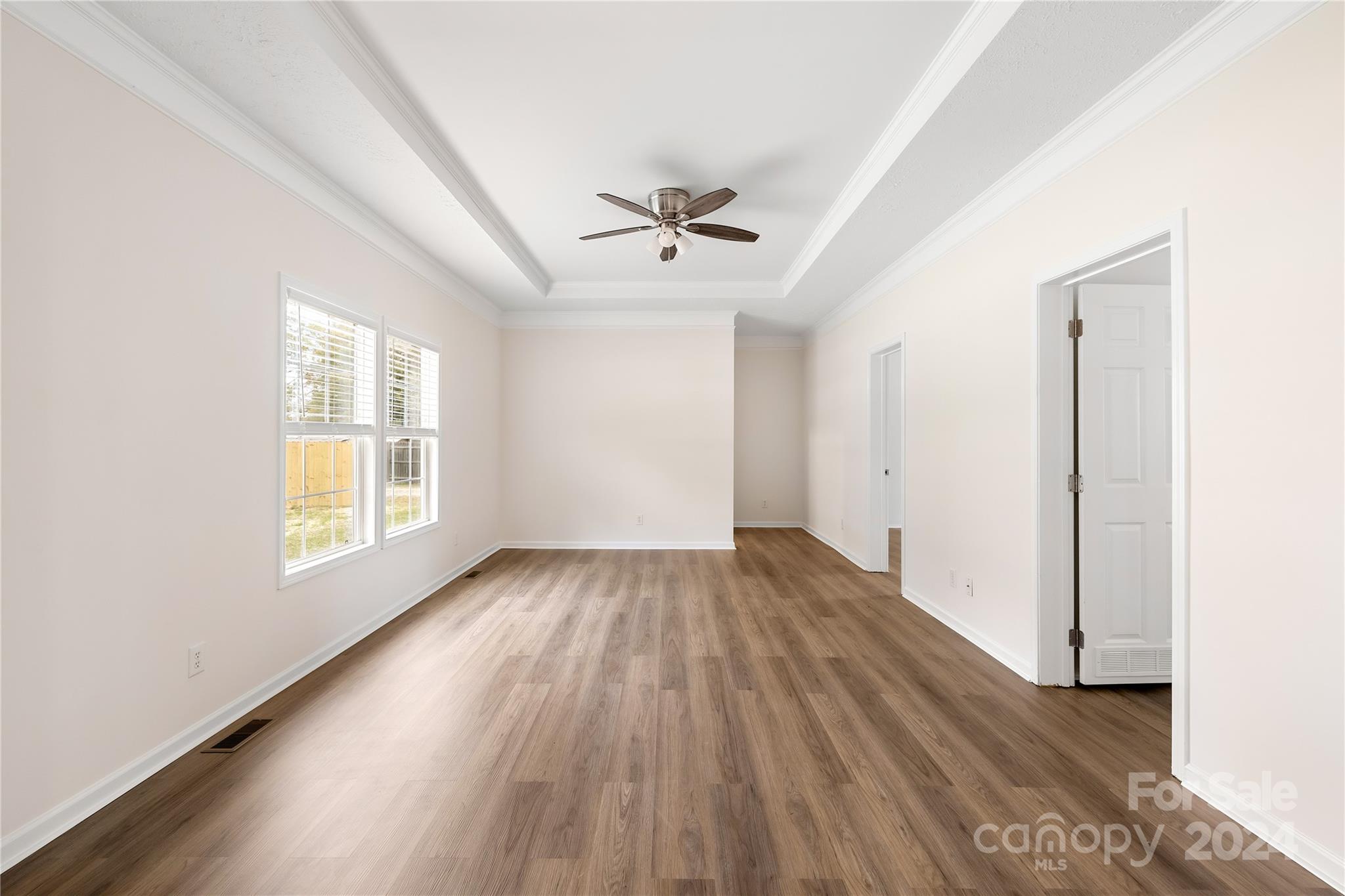 2476 Cimarron Circle Midland, NC 28107 - Photo 15 of 34 an empty room with wooden floor and windows