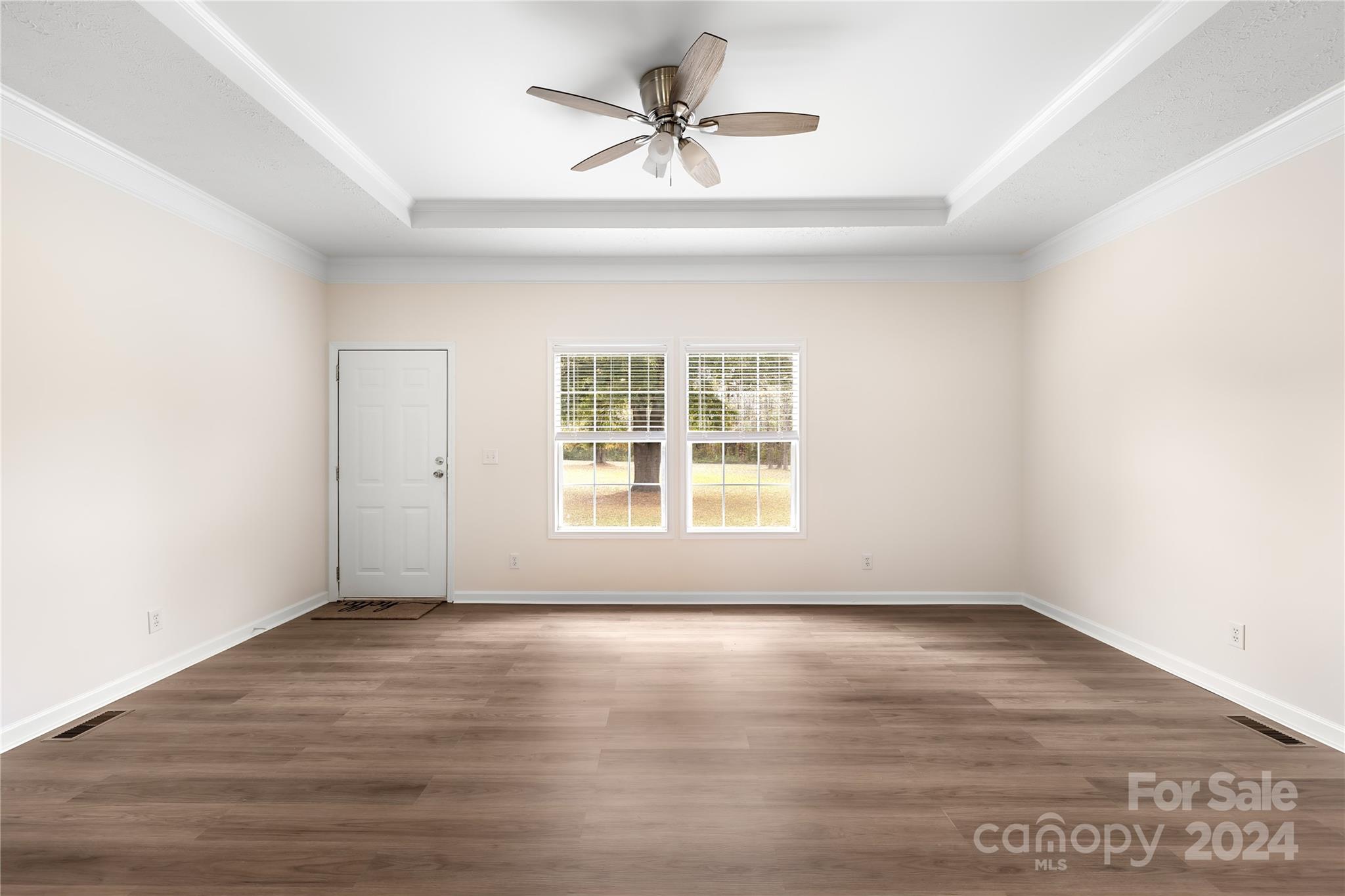 2476 Cimarron Circle Midland, NC 28107 - Photo 16 of 34 an empty room with wooden floor and windows