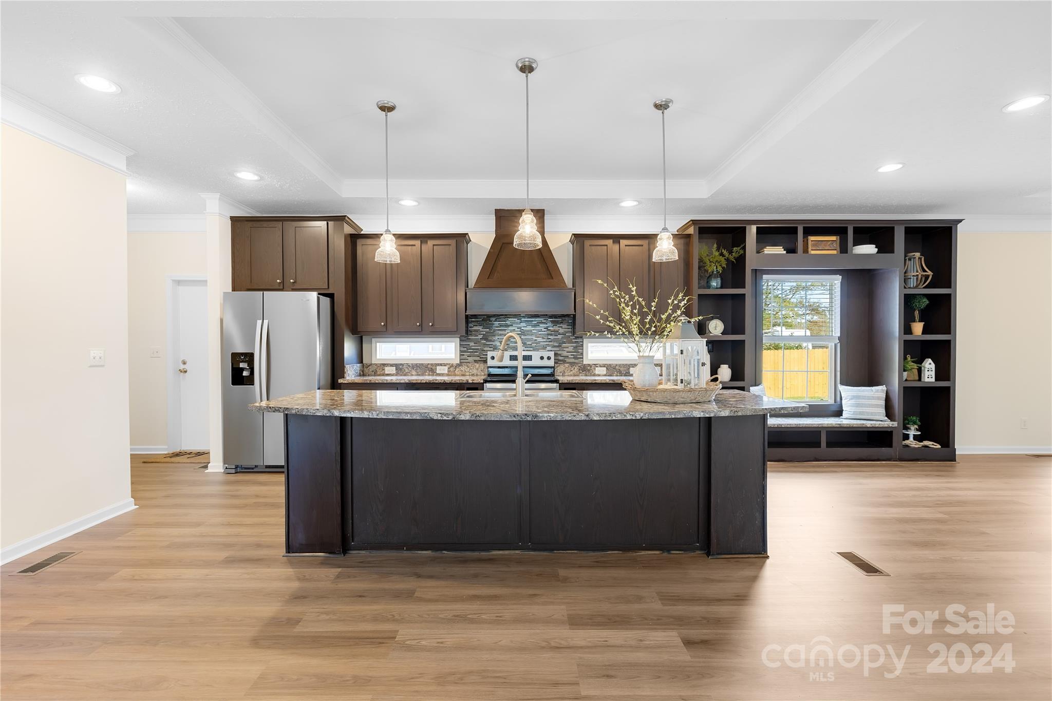 2476 Cimarron Circle Midland, NC 28107 - Photo 5 of 34 a kitchen with kitchen island granite countertop wooden cabinets and a wooden floor