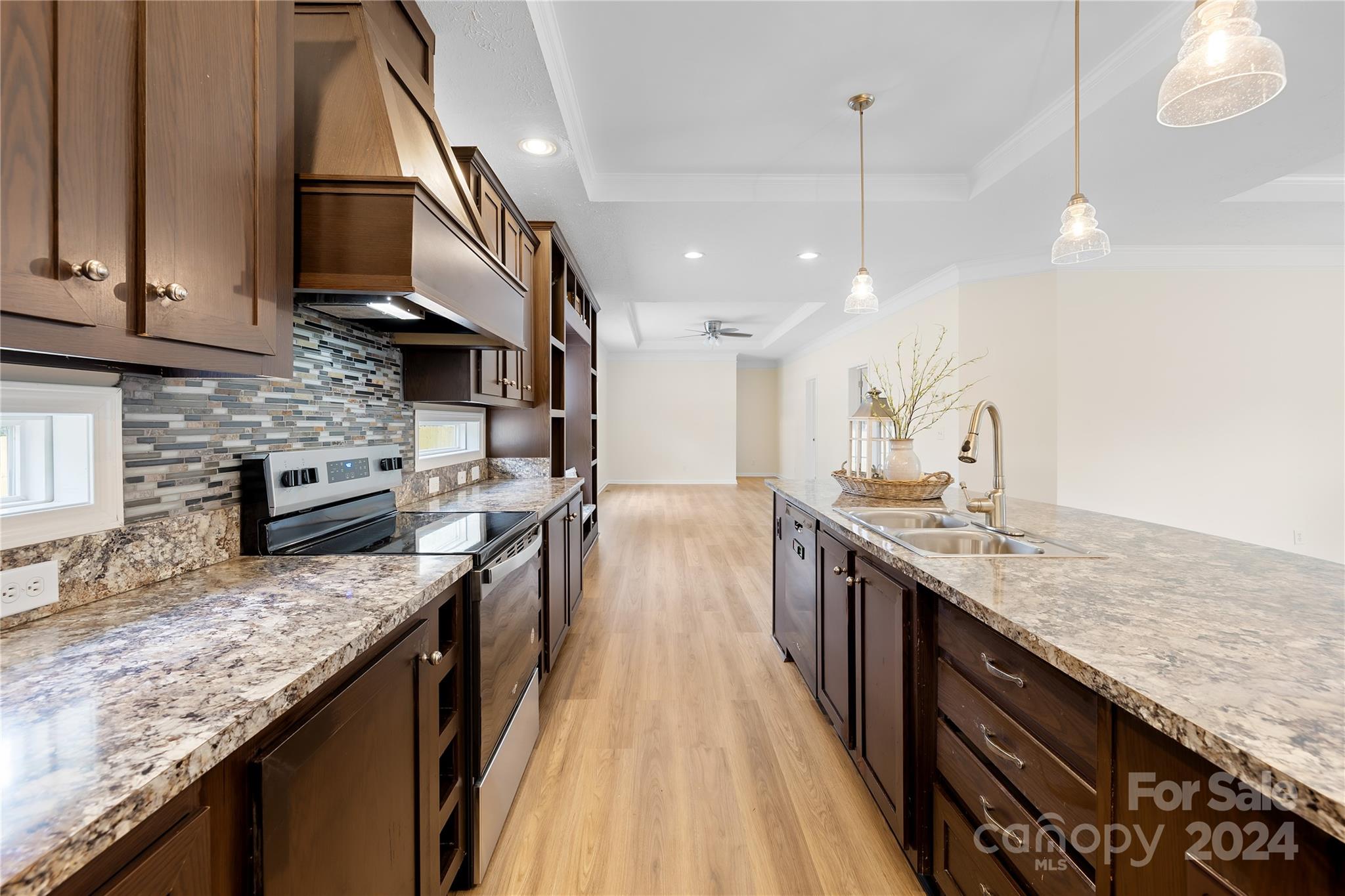 2476 Cimarron Circle Midland, NC 28107 - Photo 9 of 34 a kitchen with stainless steel appliances granite countertop a sink a stove and a wooden floors