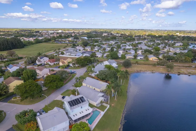 an aerial view of a house with a lake view