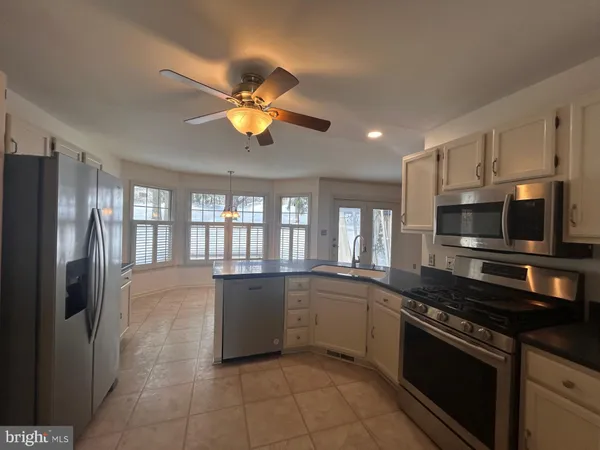 a kitchen with stainless steel appliances granite countertop a sink and stove top oven