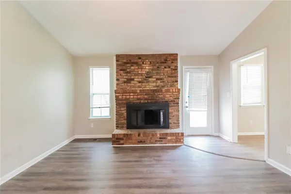 a living room with a fireplace and a window