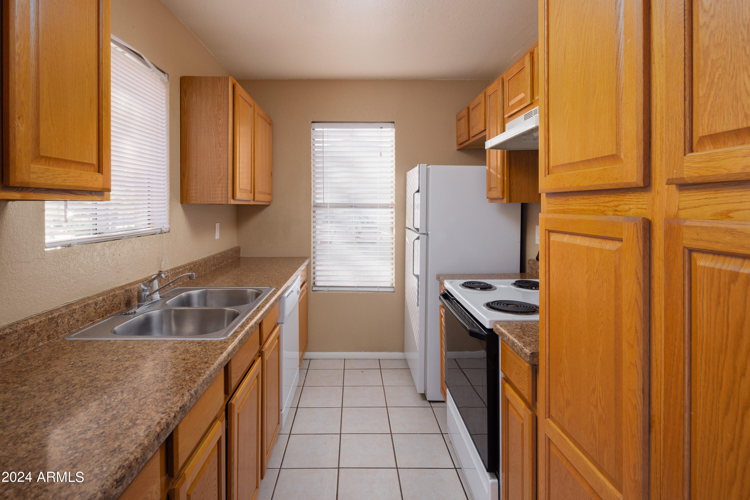 653 West Guadalupe Road, Unit 1121 Mesa, AZ 85210 - Photo 1 of 27 a kitchen with granite countertop a sink stove and refrigerator