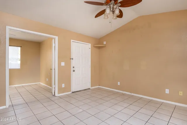 a view of a livingroom with a ceiling fan and window