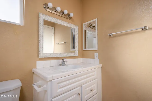 a bathroom with a sink vanity and a mirror