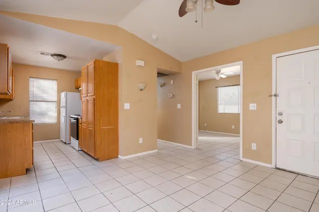 a view of a kitchen with wooden floor and a refrigerator