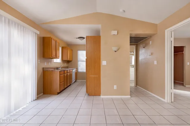 a view of a kitchen with white cabinets