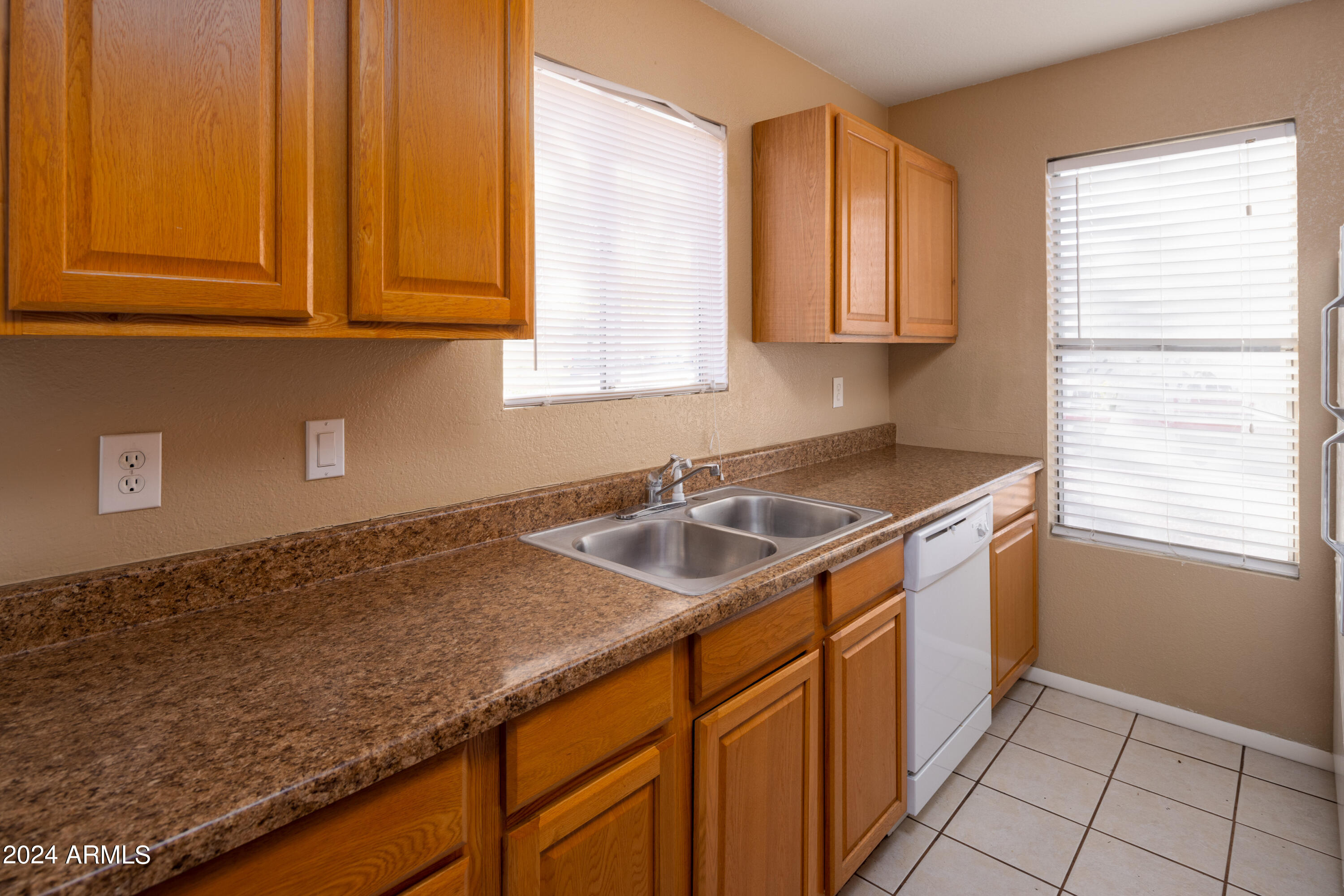653 West Guadalupe Road, Unit 1121 Mesa, AZ 85210 - Photo 9 of 27 a kitchen with stainless steel appliances granite countertop a sink stove and cabinets
