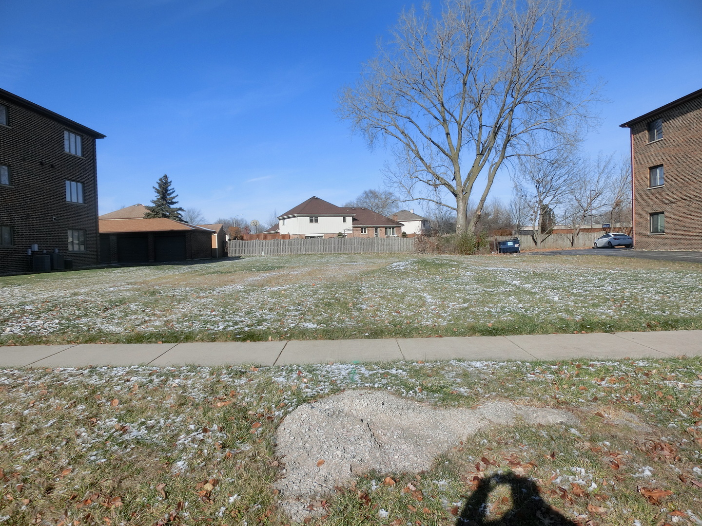 a view of a yard with a snow on the road