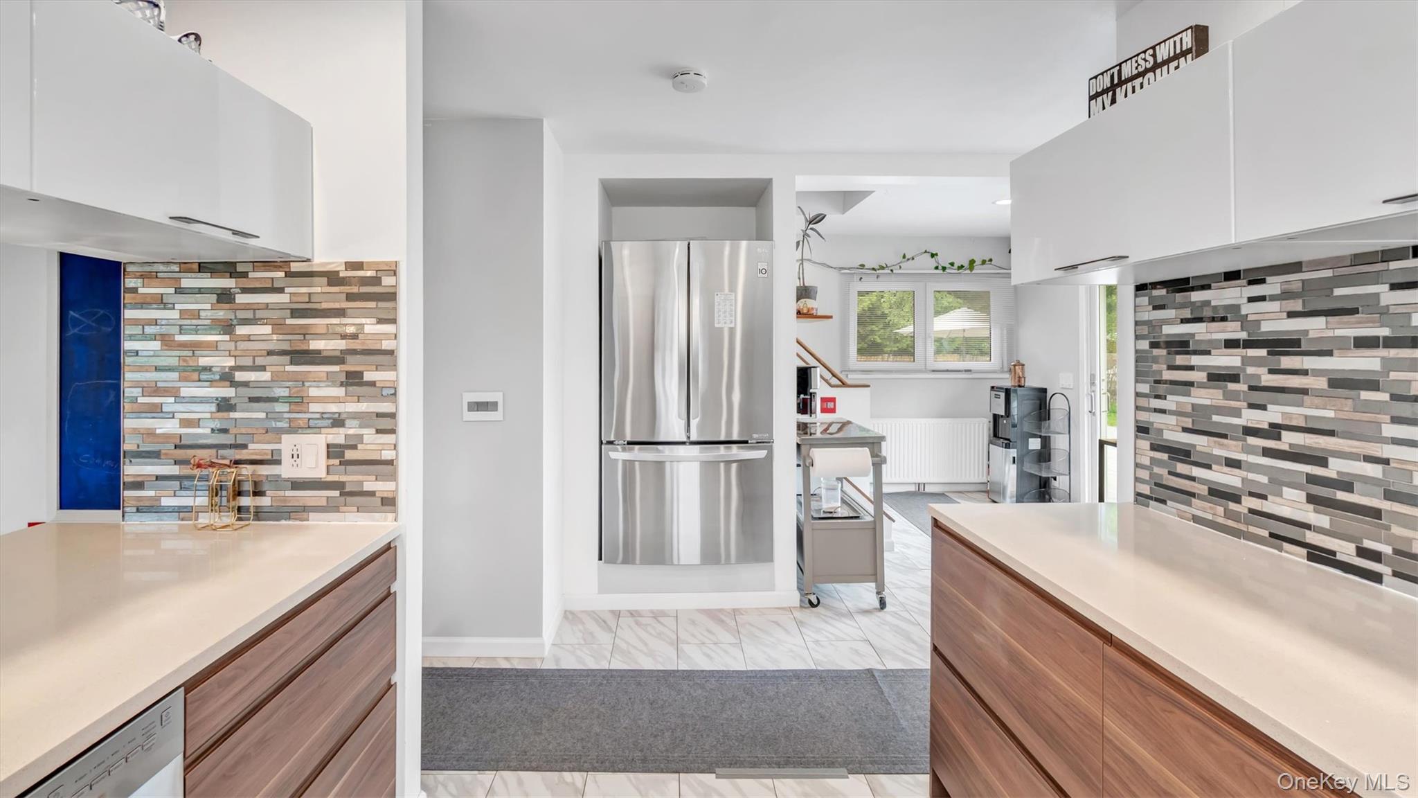 143 Hallock Street Riverhead, NY 11901 - Photo 16 of 39 a kitchen with stainless steel appliances kitchen island granite countertop a refrigerator and a sink