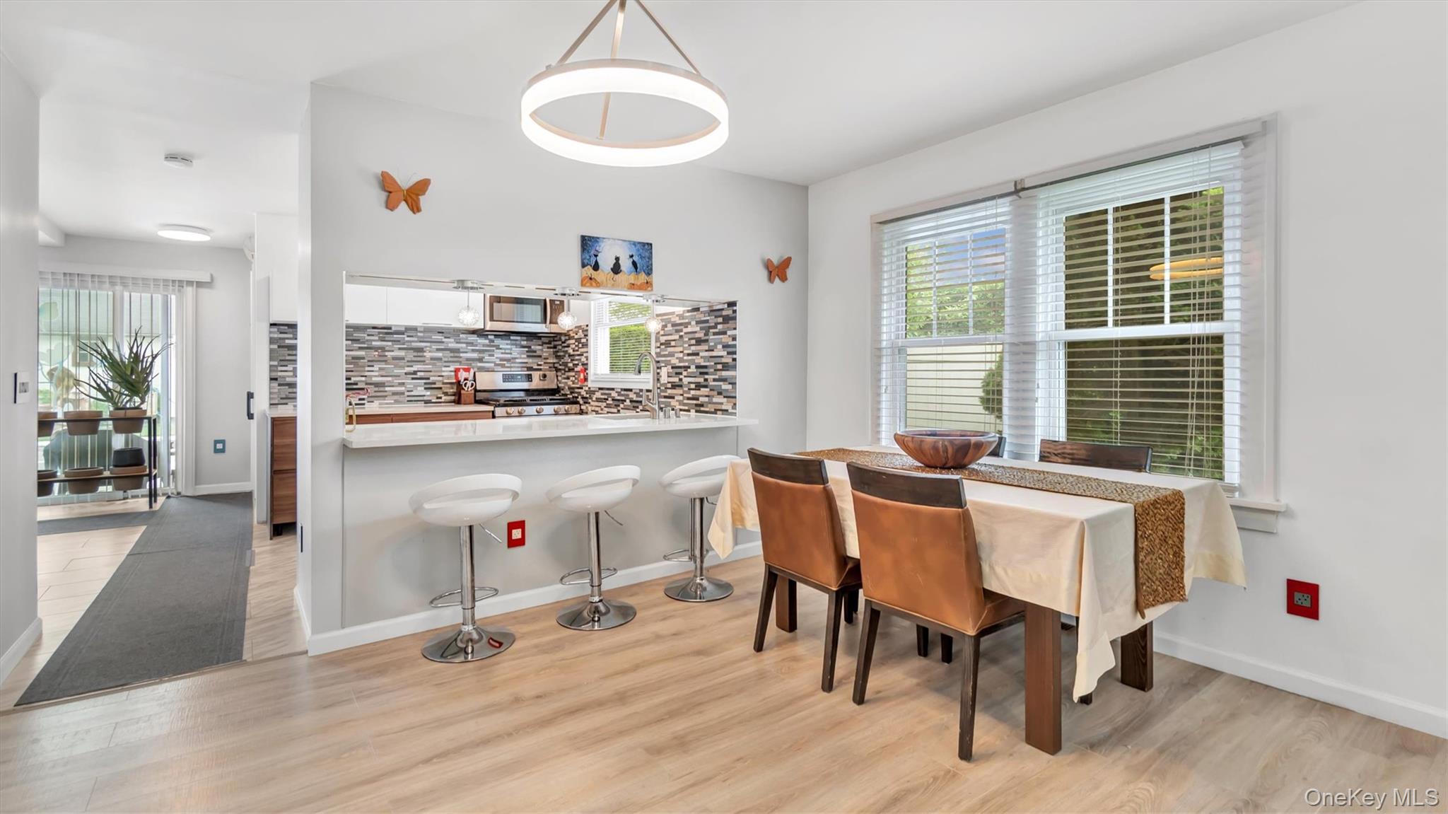 143 Hallock Street Riverhead, NY 11901 - Photo 2 of 39 a view of a dining room with furniture and a large window