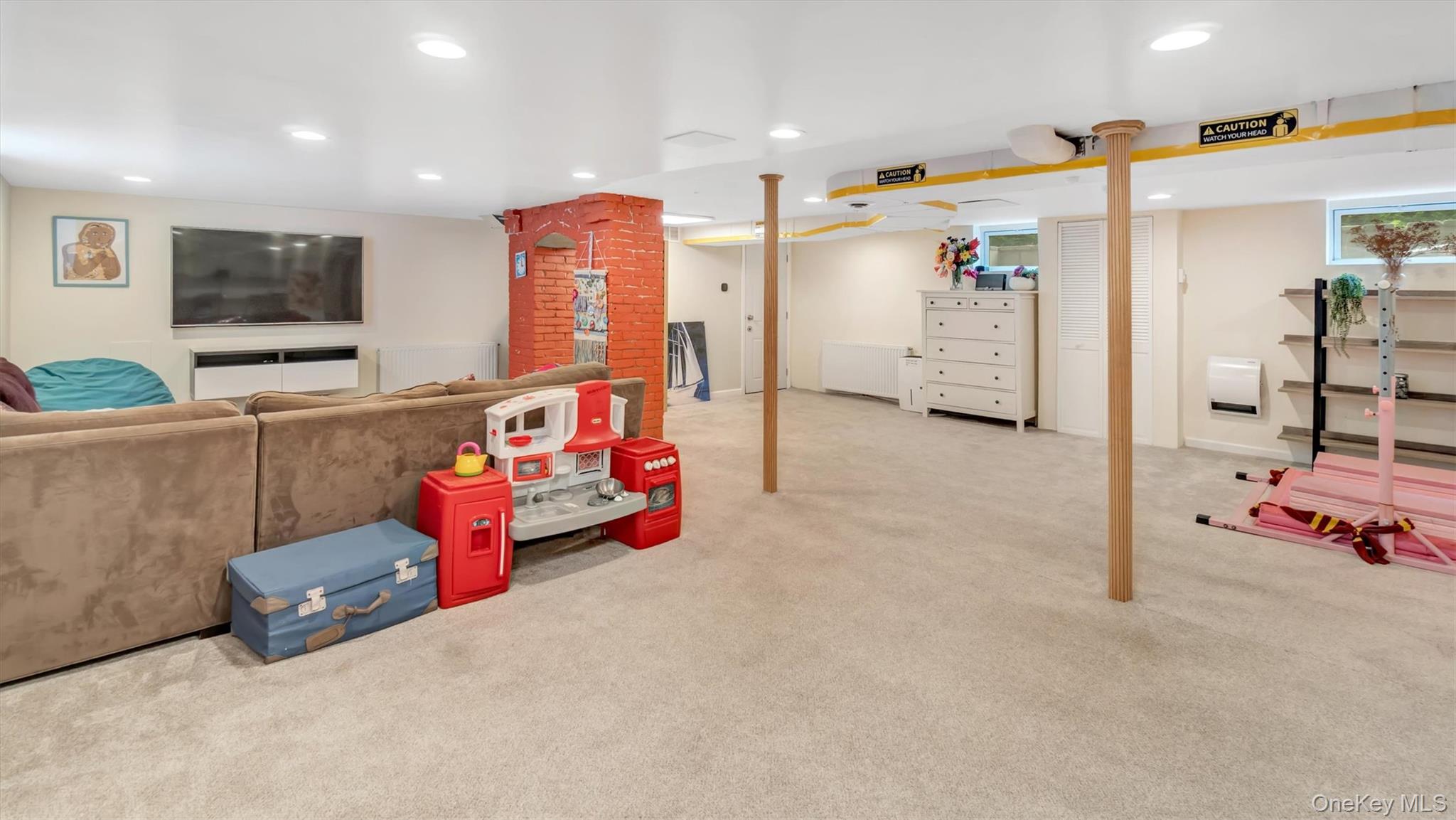 143 Hallock Street Riverhead, NY 11901 - Photo 29 of 39 a children room with furniture and a flat screen tv