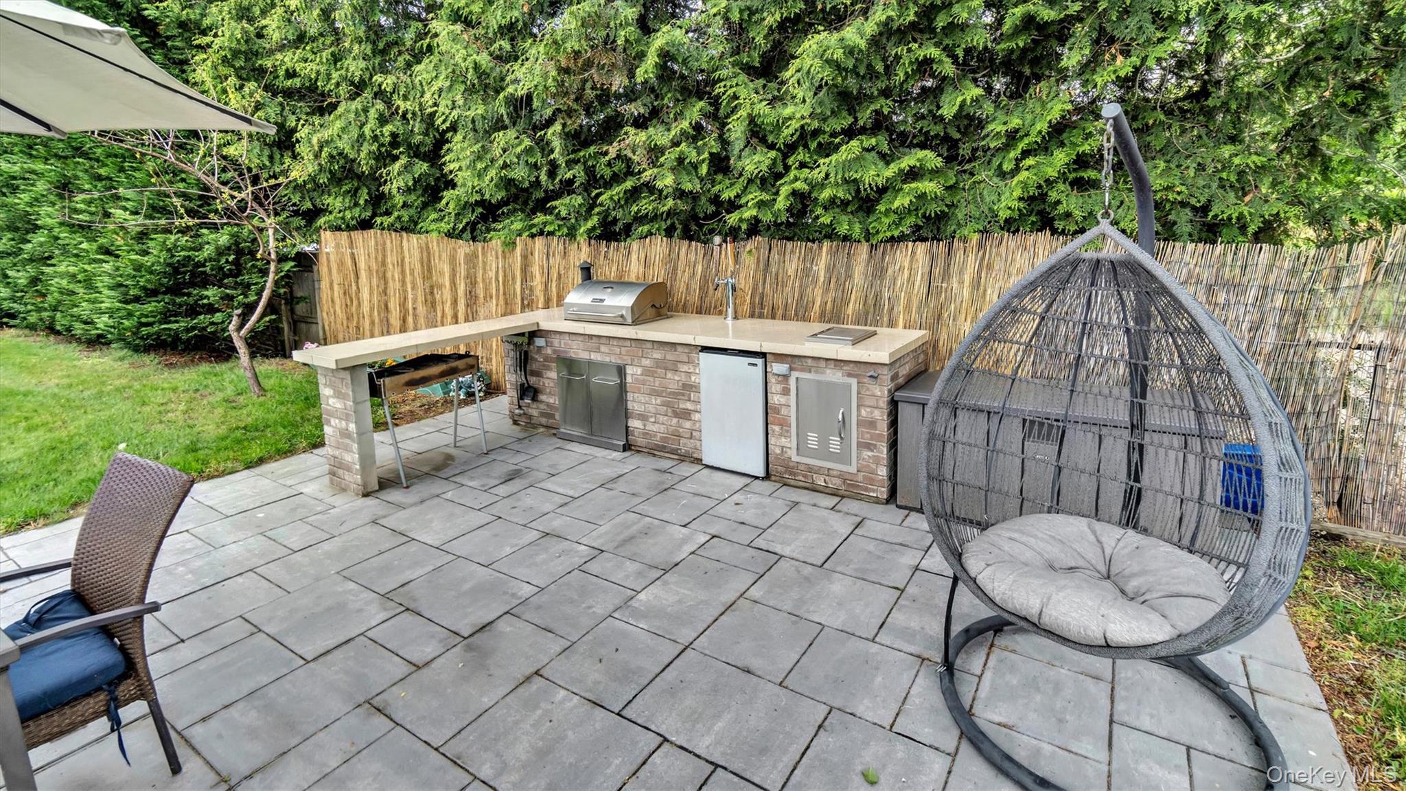 143 Hallock Street Riverhead, NY 11901 - Photo 3 of 39 a view of backyard with a table and chair