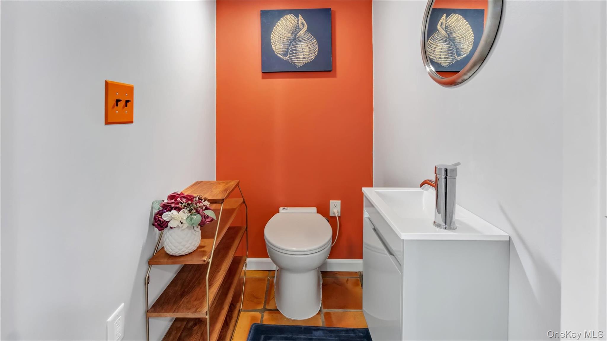 143 Hallock Street Riverhead, NY 11901 - Photo 32 of 39 a bathroom with a toilet a sink and a mirror