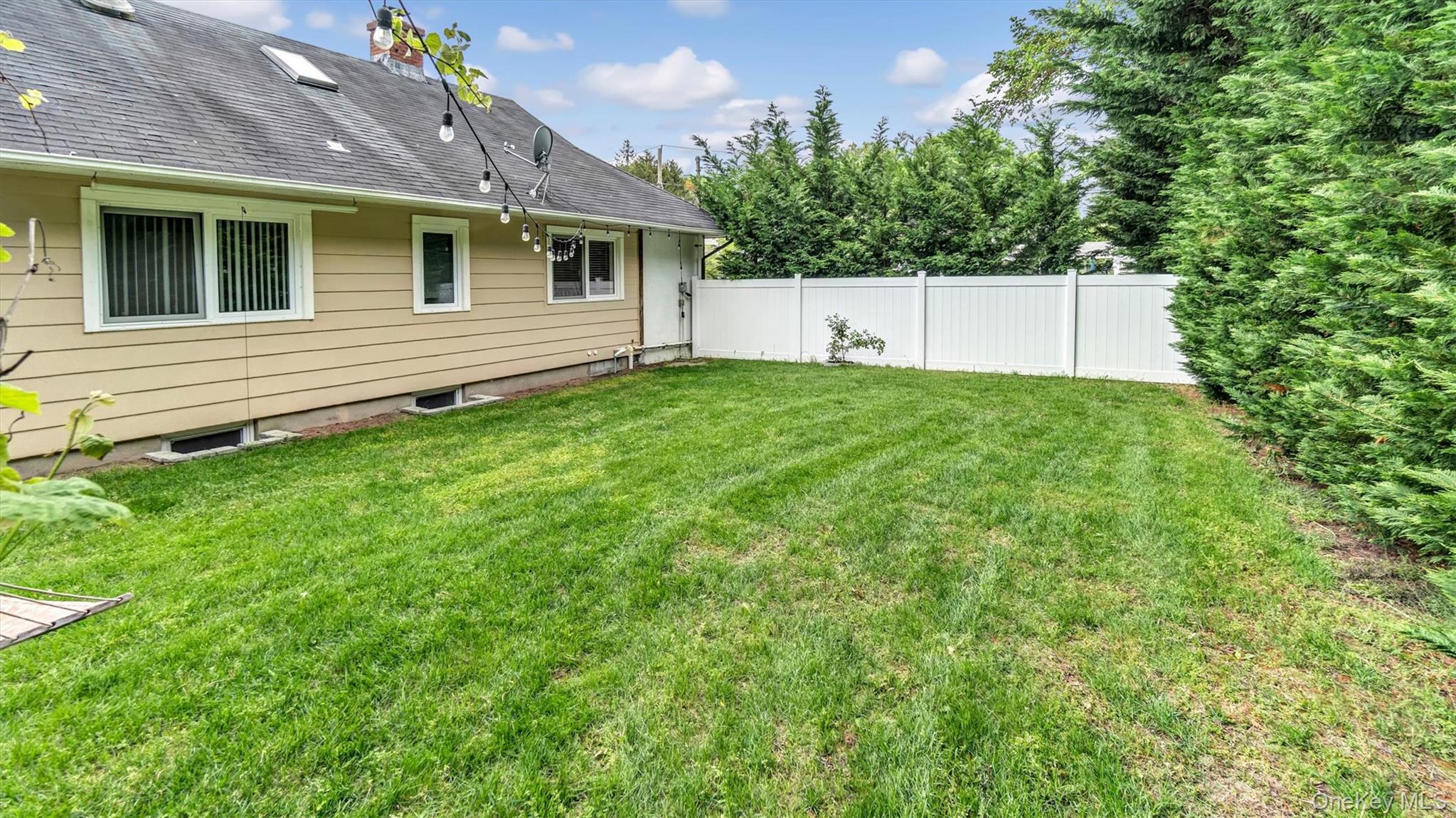 143 Hallock Street Riverhead, NY 11901 - Photo 34 of 39 a front view of a house with a yard and a garage
