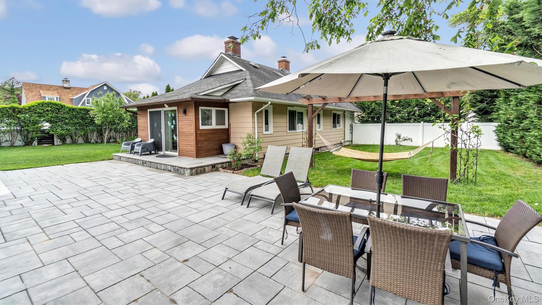 143 Hallock Street Riverhead, NY 11901 - Photo 6 of 39 a view of a patio with table and chairs under an umbrella