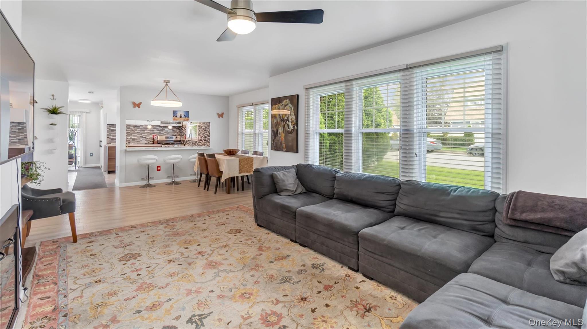 143 Hallock Street Riverhead, NY 11901 - Photo 10 of 39 a living room with furniture and a large window