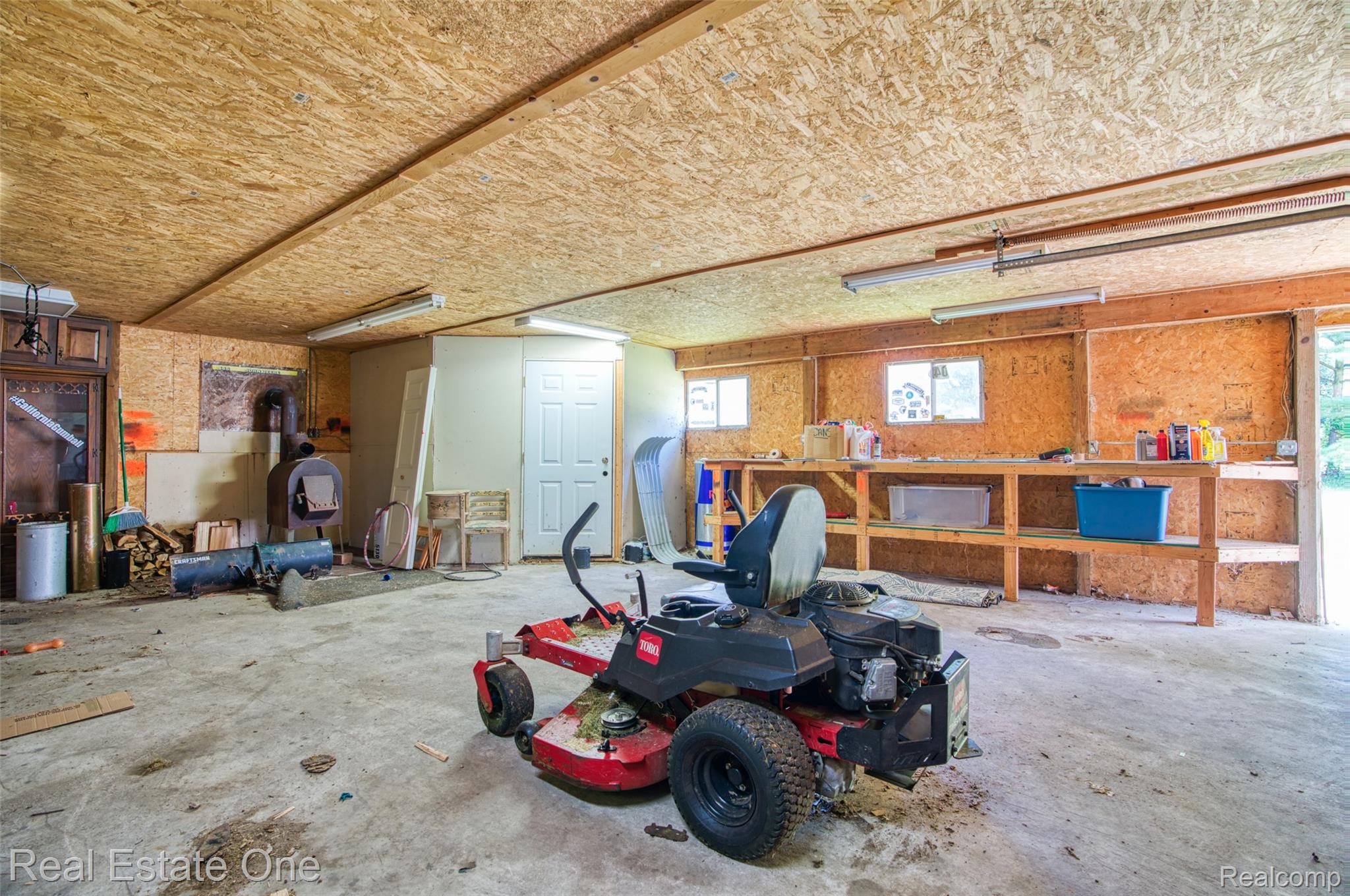 5130 Iosco Road Webberville, MI 48892 - Photo 32 of 39 Concrete flooring with exposed wood-finish walls and ceiling