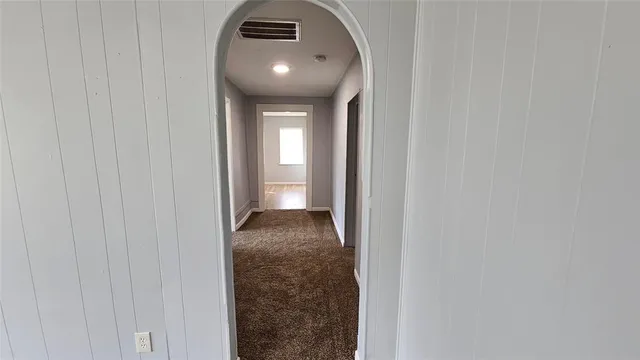 a view of a hallway with a wooden floor