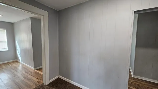 a view of hallway with wooden floor