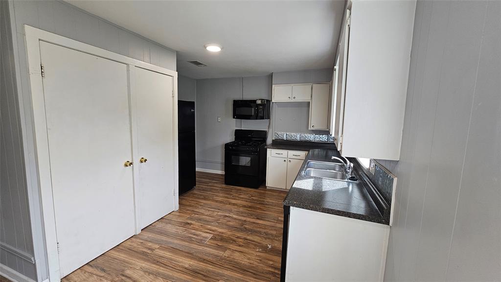 904 Duncan Street Denton, TX 76205 - Photo 26 of 40 a kitchen with a refrigerator and a stove top oven