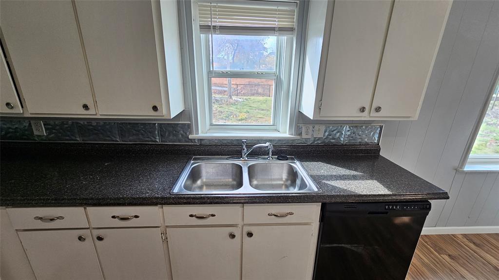904 Duncan Street Denton, TX 76205 - Photo 29 of 40 a kitchen with granite countertop a sink a stove and cabinets