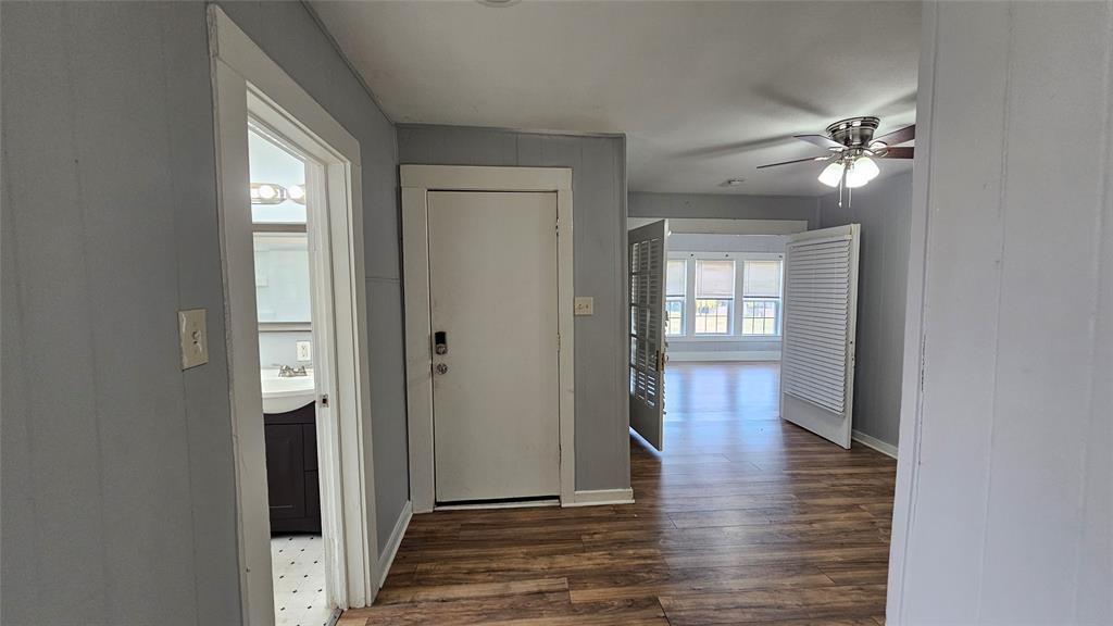 904 Duncan Street Denton, TX 76205 - Photo 32 of 40 a view of a hallway with wooden floor and a bathroom