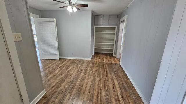 a view of hallway with wooden floor