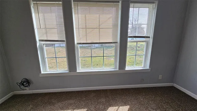 an empty room with wooden floor and closet