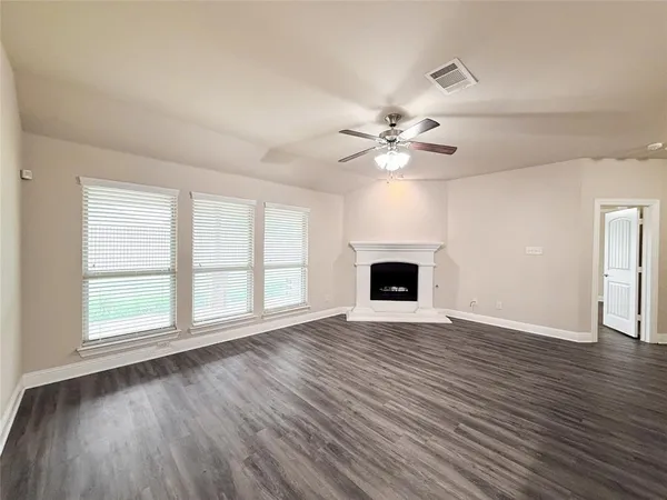 a view of open kitchen with sink and fireplace