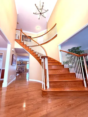 a view of entryway and hall with wooden floor