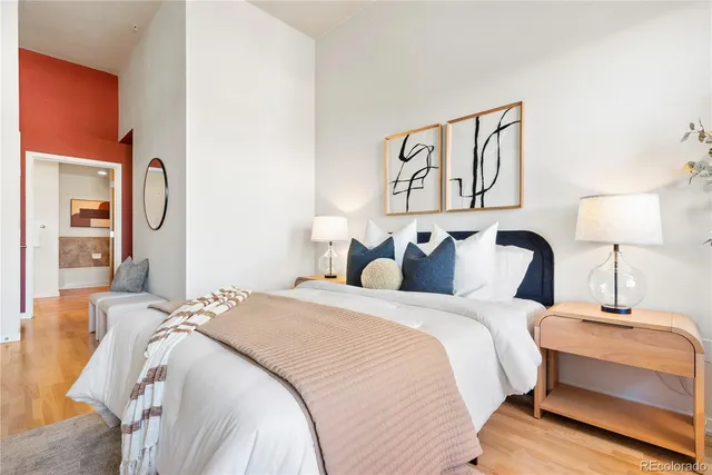 a bedroom with bed and cupboard