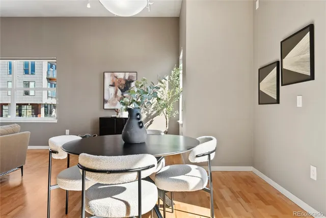 a dining room with furniture and wooden floor