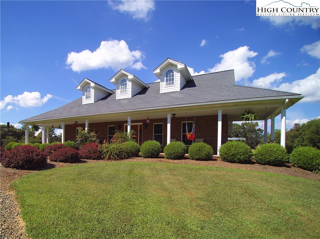 931 Graystone Road Independence, VA 24348 - Photo 1 of 32 a front view of a house with garden