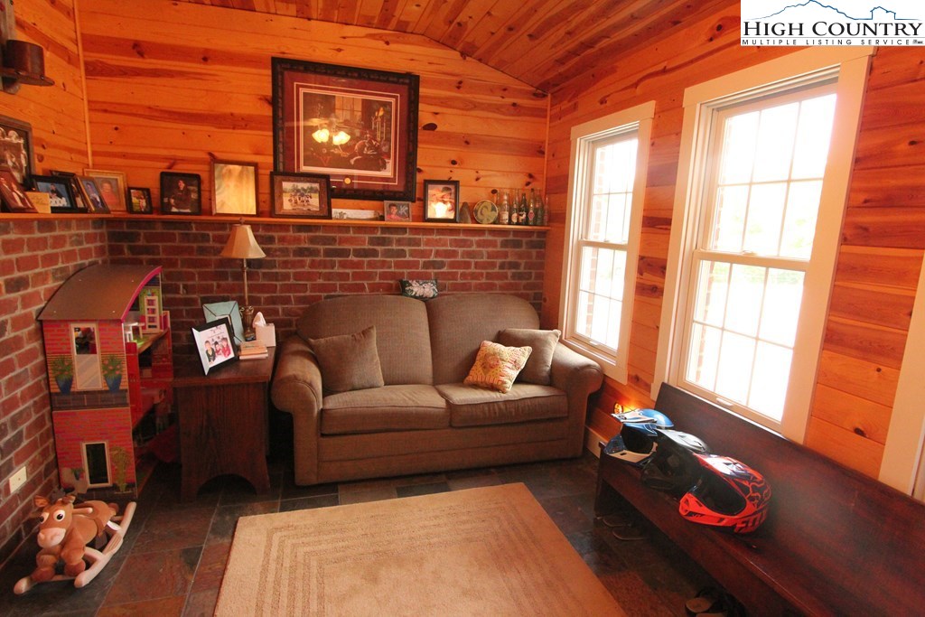 931 Graystone Road Independence, VA 24348 - Photo 13 of 32 a living room with furniture and a floor to ceiling window