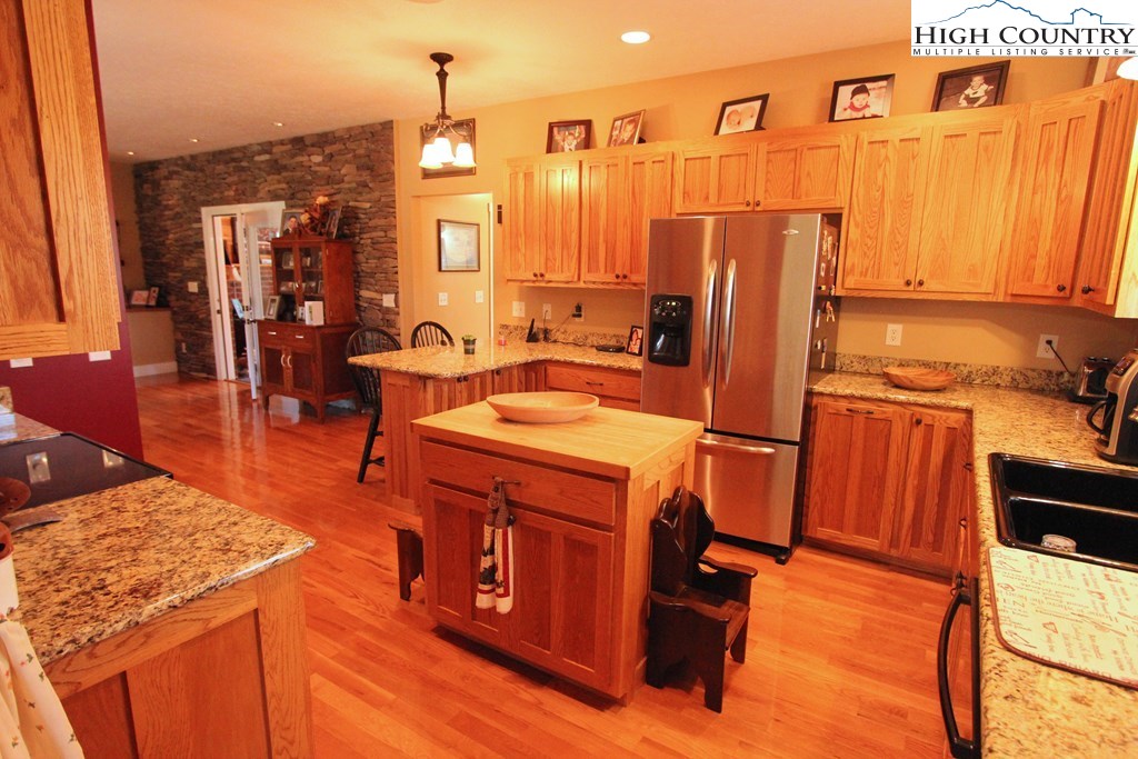 931 Graystone Road Independence, VA 24348 - Photo 15 of 32 a view of a kitchen with kitchen island dining table and chairs
