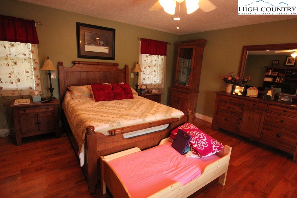 931 Graystone Road Independence, VA 24348 - Photo 16 of 32 a bedroom with a bed and wooden floor