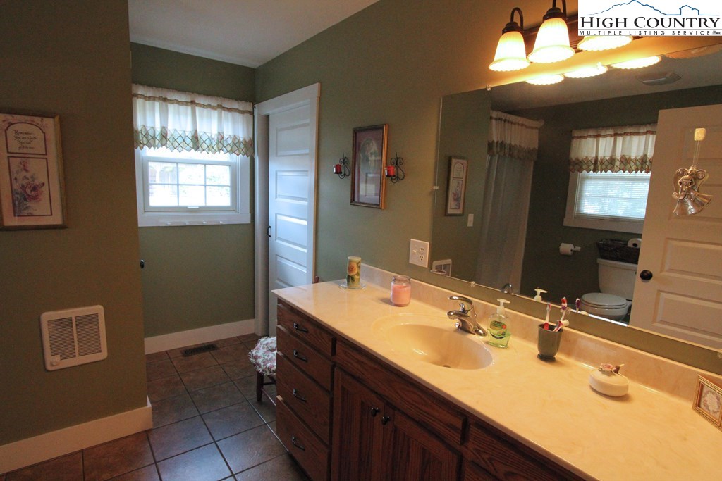 931 Graystone Road Independence, VA 24348 - Photo 17 of 32 a bathroom with a sink vanity and a mirror