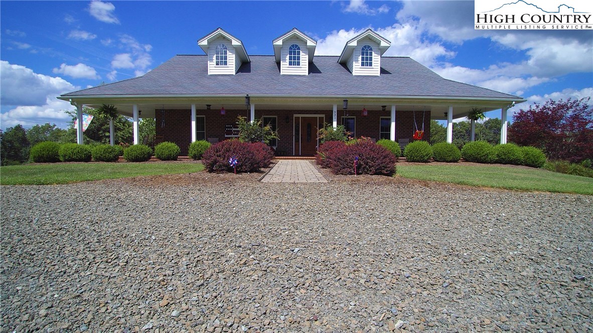 931 Graystone Road Independence, VA 24348 - Photo 5 of 32 a front view of a house with garden