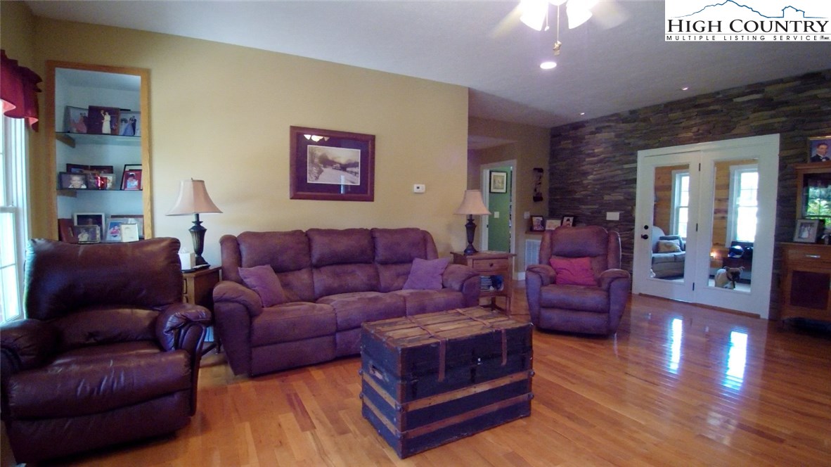 931 Graystone Road Independence, VA 24348 - Photo 9 of 32 a living room with furniture and a wooden floor