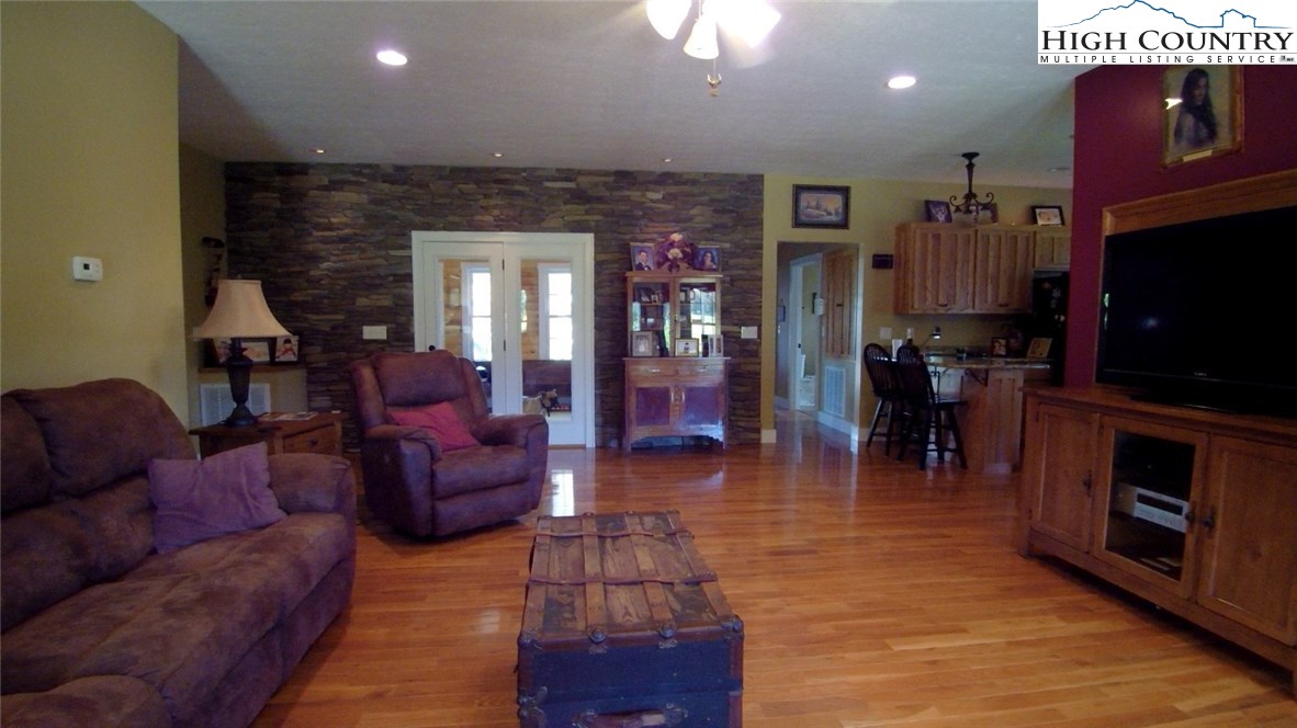 931 Graystone Road Independence, VA 24348 - Photo 10 of 32 a living room with furniture a flat screen tv and kitchen view