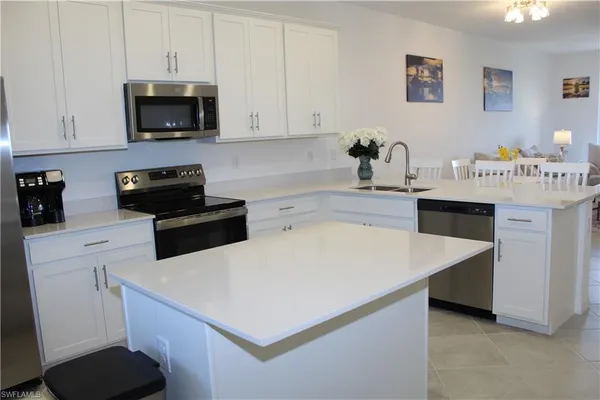 a kitchen with a sink a stove and cabinets