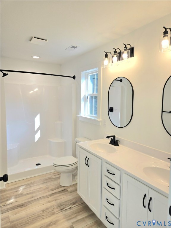 1737 Bumpass Road Bumpass, VA 23024 - Photo 26 of 26 a bathroom with a double vanity sink mirror toilet and shower
