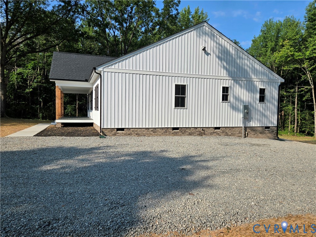 1737 Bumpass Road Bumpass, VA 23024 - Photo 4 of 26 a view of a white house with a yard and large tree