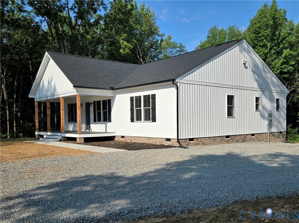 1737 Bumpass Road Bumpass, VA 23024 - Photo 5 of 26 a view of a white house with a yard and large trees