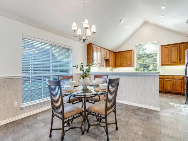 a view of a dining room with furniture and chandelier