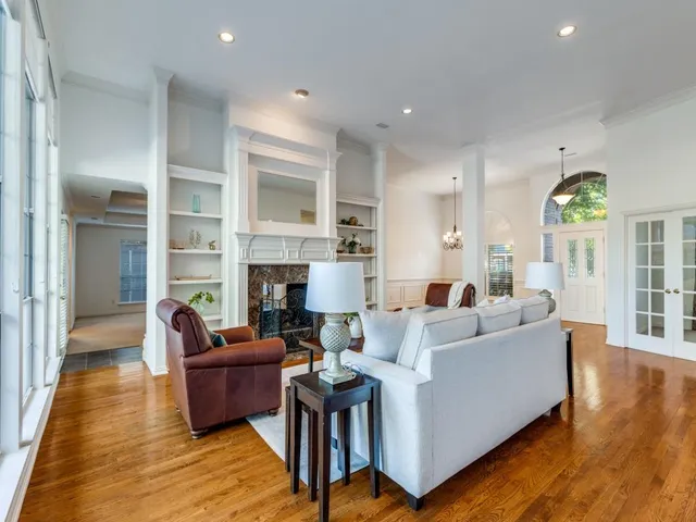 a living room with fireplace furniture and a wooden floor