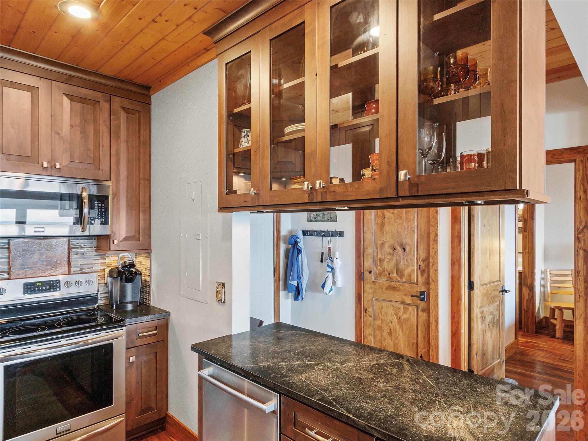 80 Slickrock Road, Unit A4 Burnsville, NC 28714 - Photo 13 of 30 a kitchen with stainless steel appliances granite countertop a stove and a refrigerator