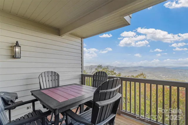 a roof deck with a table and chairs